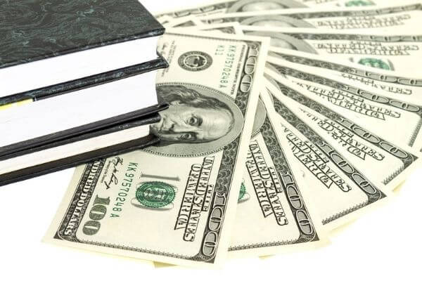 Picture of books with hundred dollar bills for the best personal finance books overall.