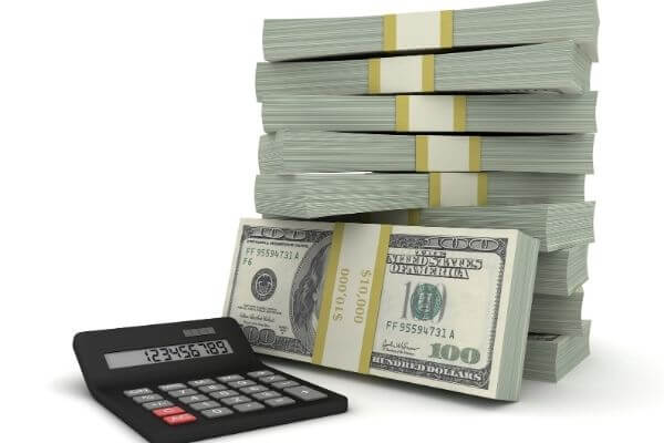 Picture of a stack of cash and calculator for the 30 day money saving challenge.