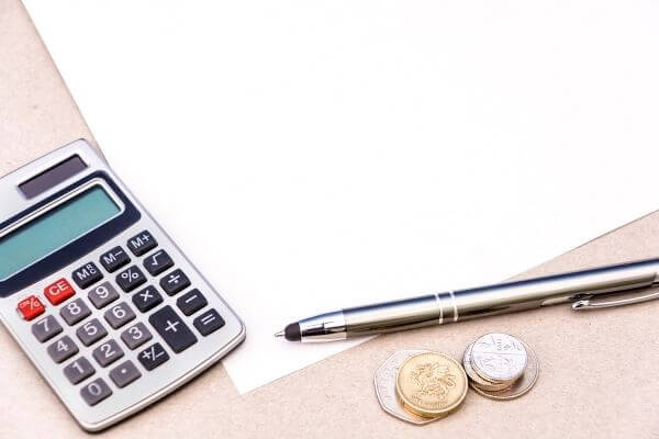 Picture of calculator and pen to figure out how much do I make a year.