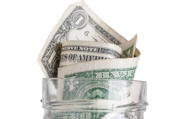 Picture of cash in a jar for how to save for your fun money.