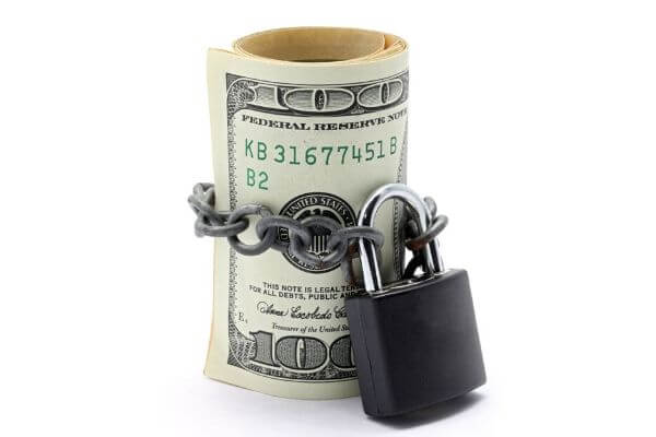 Picture of cash wrapped up in a lock for What is a No Spend Challenge