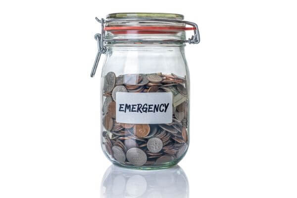 Picture of a jar stuffed with coins for emergency expenses