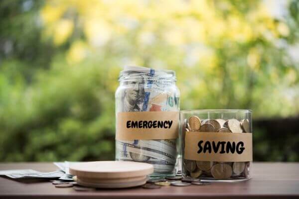 Picture of money saving jars to show the reason why proper money management leads to becoming financially sound