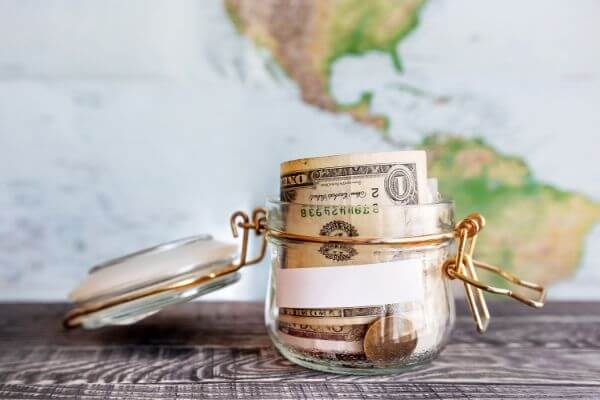 Picture of vacation fund jar to help you save money for travel.