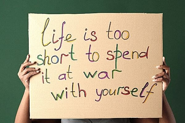 Picture of a sign saying "Life is too short to spend it at war with yourself" for the 30 day productivity challenge.