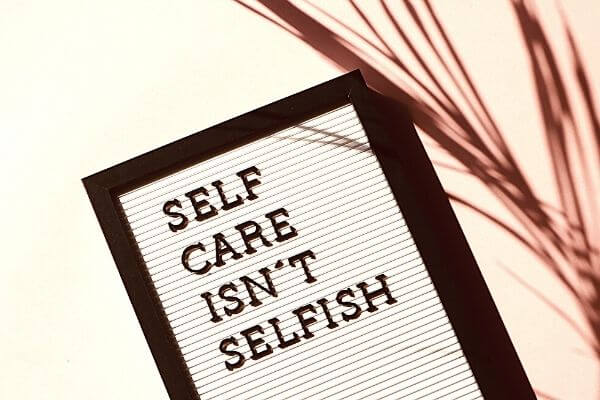 Picture of lettering for a 30 day self care challenge saying self care isn't selfish.