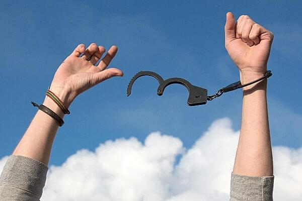 Picture of someone taking of handcuffs as a way to show why release your money blocks.