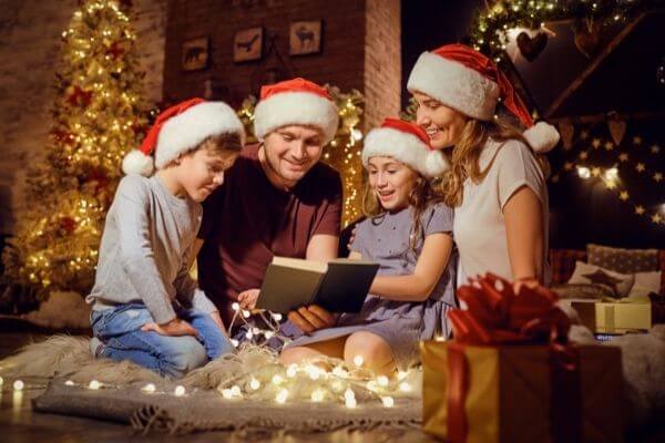 Picture of a family reading Christmas book. 