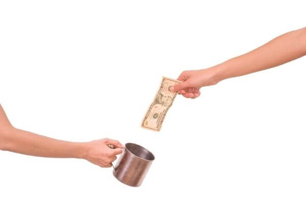 Picture of someone putting money into the habit jar to save money and break bad habits.