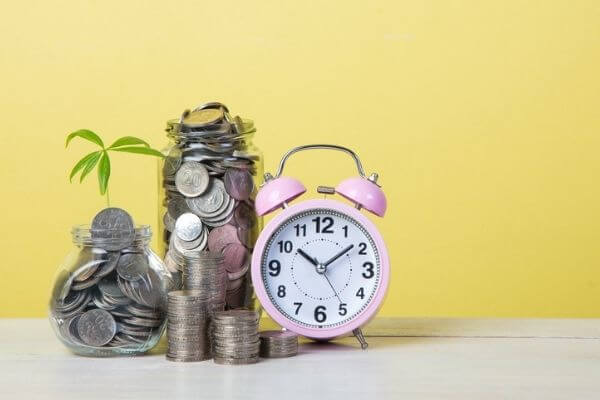 Picture of coins and a clock for the best money hacks.