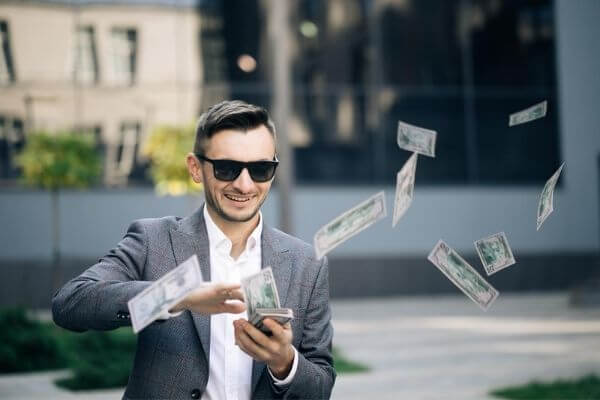 Picture of a guy throwing money after a profitable trade.