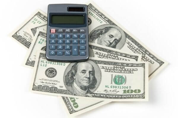 Picture of a calculator and money for the 35 an hour salary calculator. 