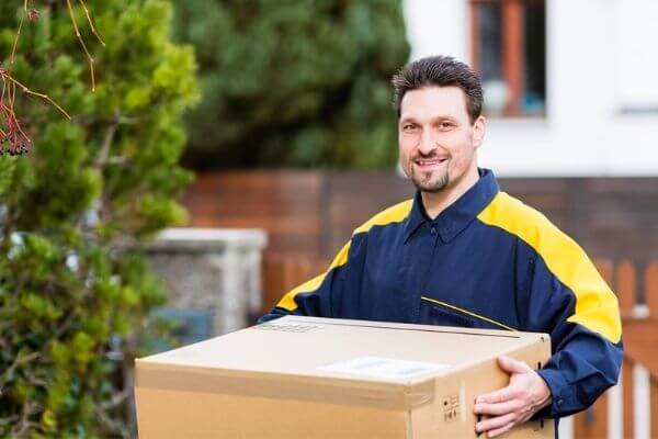 Picture of a guy working on early morning job as a package delivery person.