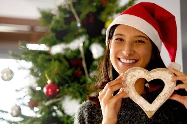 Picture of a lady holding a heart with how can I get Christmas with no gifts.