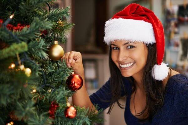 Picture of a lady working on decoration for Christmas tree.