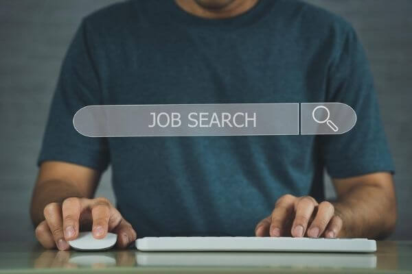 Picture of a search bar overlayed on a person at a computer for where to find morning jobs near me.