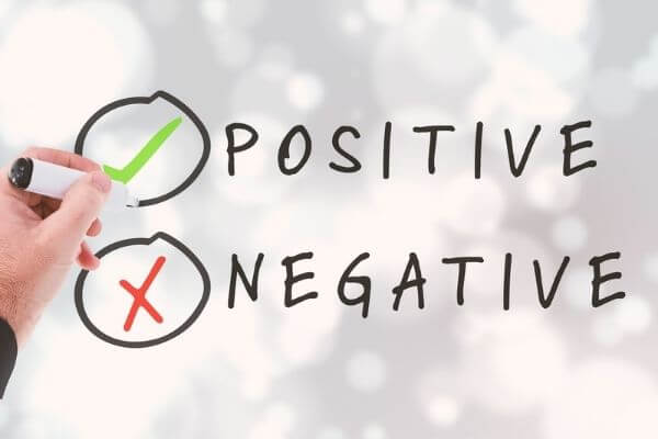 Sign that says positive and negative for the pros and cons of REITs.