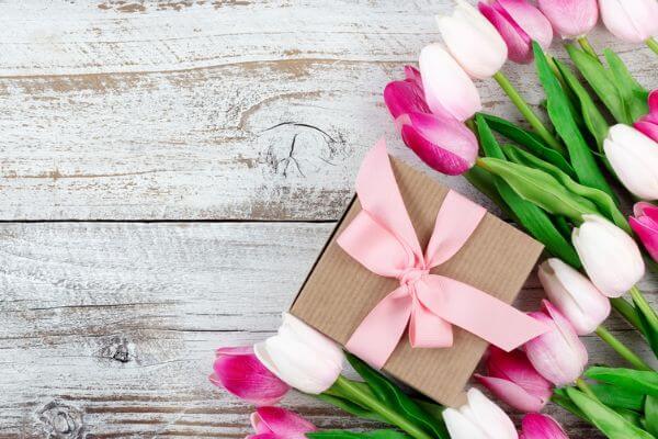 Picture of flowers and a gift for what are some ways to show appreciation.