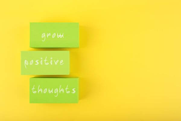 Picture of a sign that says grow positive thoughts for how do affirmations work.