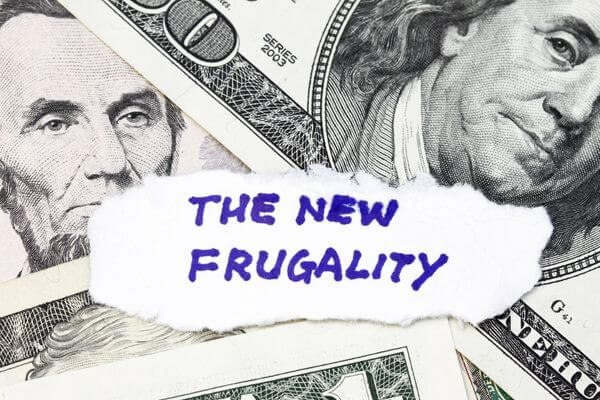 Picture of money with a sign that says the new frugality for ready to live life frugal green.