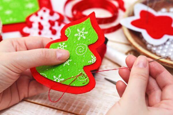 Picture of someone making a Christmas tree craft.