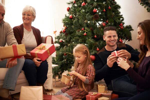 Picture of a family giving Christmas gifts as you wonder do I have to give gifts at Christmas.