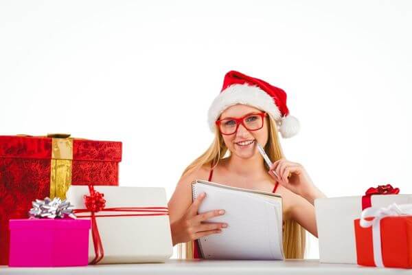 Picture of a lady writing a Christmas gift list