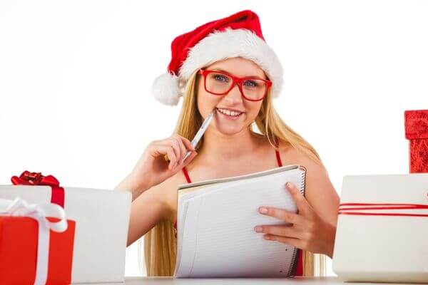 Picture of a lady putting together the ultimate Christmas bucket list.