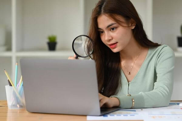 Picture of a lady and a laptop for the components of a personal financial statement.