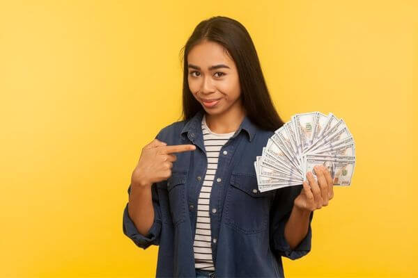 Picture of a lady holding cash for money tips for finding virtual assistant jobs.