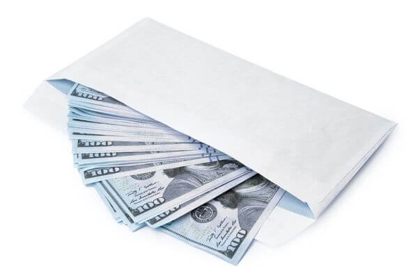 image of a white envelope stuffed with cash after completing the 100 envelope challenge printable.