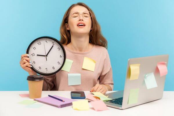 Picture of a lady with a clock wanting to know the best excuses to leave work early.