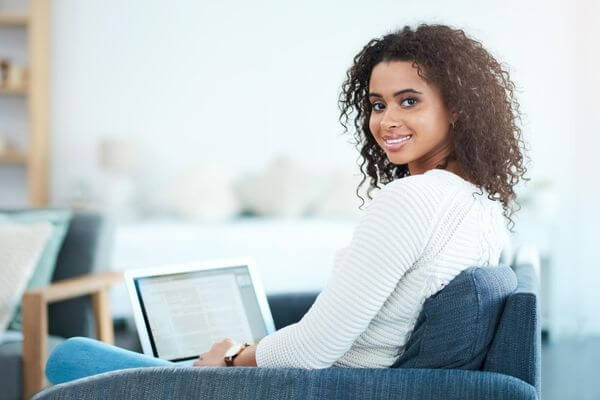 Picture of a lady comfortable on a coach for what can I get started with virtual assistant jobs.