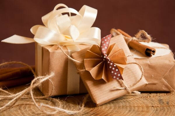 Picture of brown bag wrapped gifts for why choose consumable Christmas gifts.