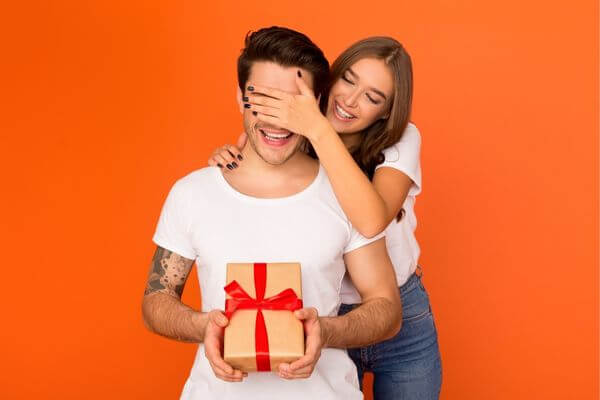 Picture of a guy opening a consumable gifts for him.