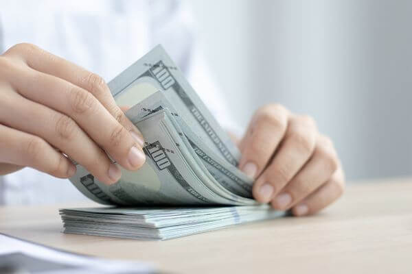 Picture of a stack of cash for what is the least stressful jobs that pays well.