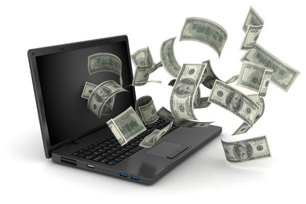 Picture of a laptop with money coming out of it.