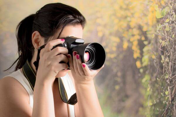 Picture of a lady taking pictures for how do I get pictures for my vision board.