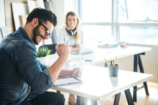 Picture of man exited about how can I leave work early without getting in trouble.