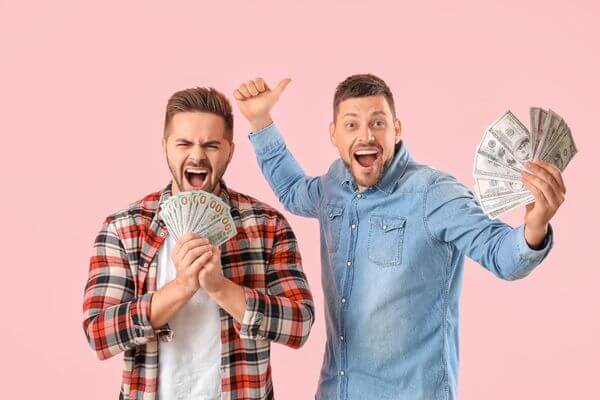 Picture of guys holding cash after making money working as waitstaff for a catering job.