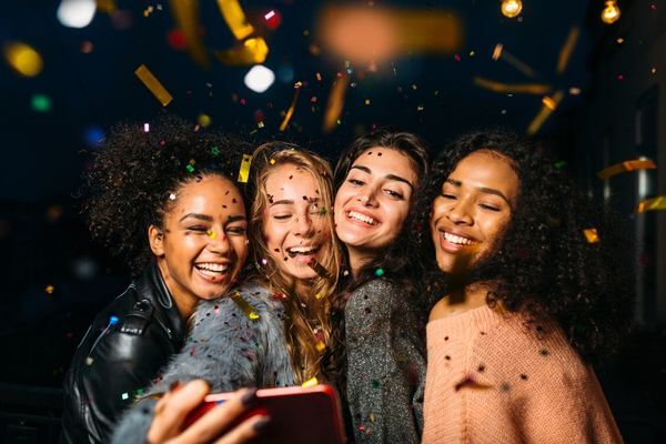 Picture of a group of ladies taking a picture for why plan a vision board party.