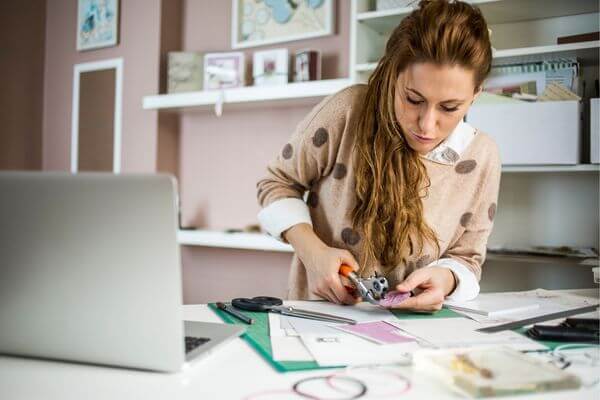 Picture of a lady creating her dream board visualization.