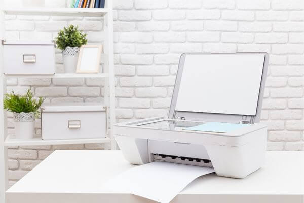 Picture of a printer on a desk for find vision board picture to print.