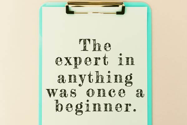 picture of a sign for inspirational vision board quotes that says the expert in anything was once a beginner.