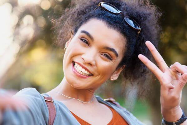 Picture of a happy lady who worked through her burnout to want to go to work.