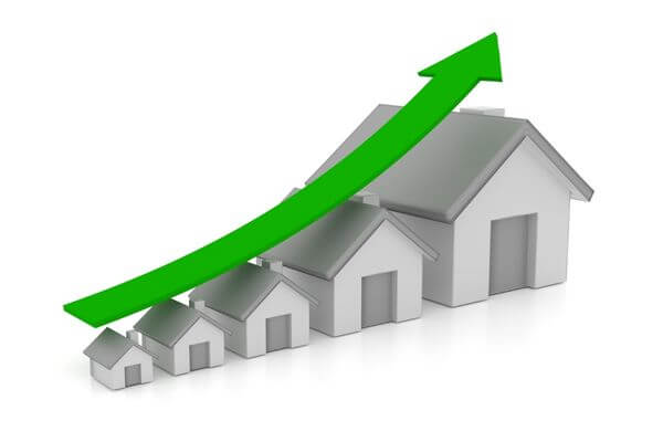 Graphic of a row of houses that increase in size with a price arrow going up.