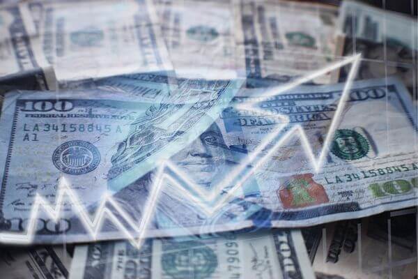 A picture of dollar bills with an increasing net worth arrow.  