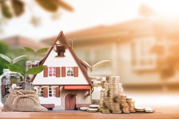 Picture of a house and coins for home buying by down payment.