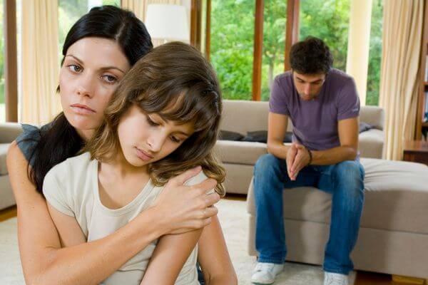 Picture of a family comforting a child for what is a good family emergency excuse.