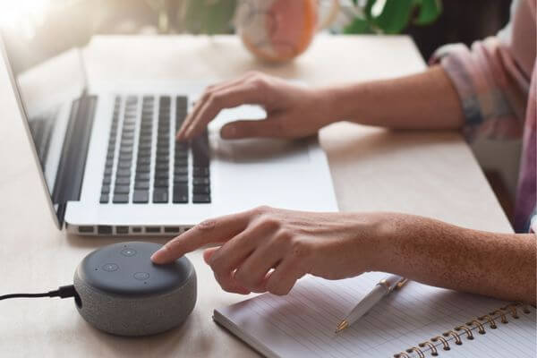 Picture of a woman doing clerical work on a laptop.